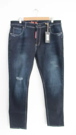 Jean Premium de alta calidad para hombre, corte moderno, color azul oscuro con desgastes, destroyer en pierna derecha, bordado en parte trasera