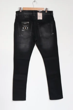 Jean Premium de alta calidad para hombre, corte moderno, color gris humo oscuro con parche en pierna derecha, nips, destroyer, desgastes pines y botón contramarcado, bordado Monastery en parte trasera